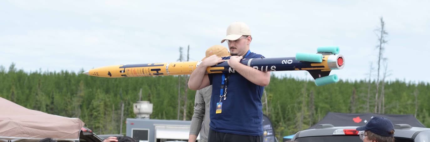 Djordje carrying a competition rocket at a McMaster Rocketry launch